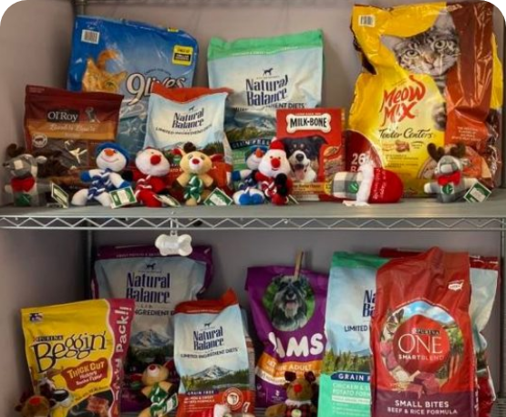 A shelf with cat and dog food and toys.