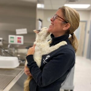 A woman holding a cat